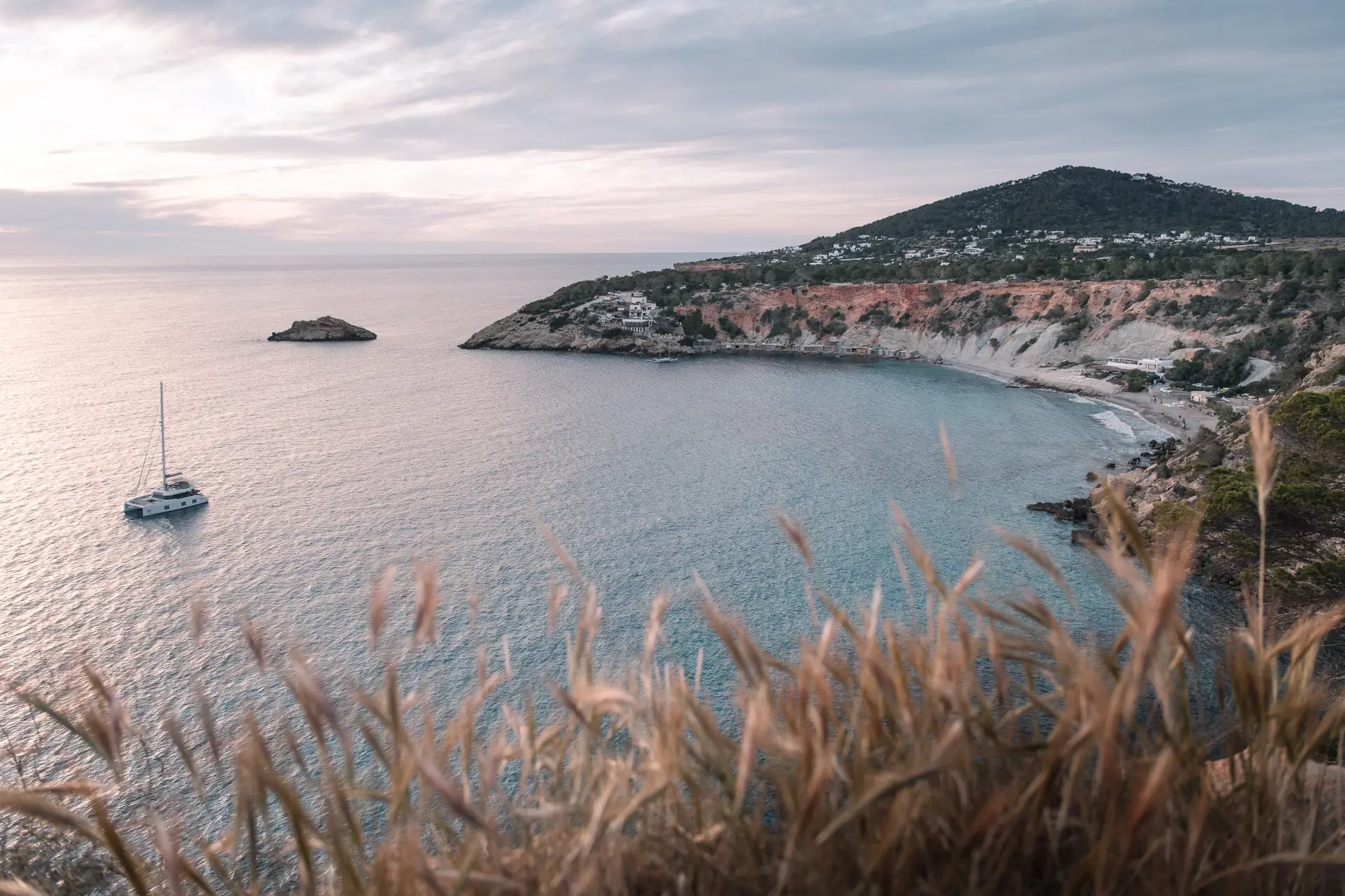 Cala d’Hort coastline, steep cliffs meeting the calm Mediterranean.