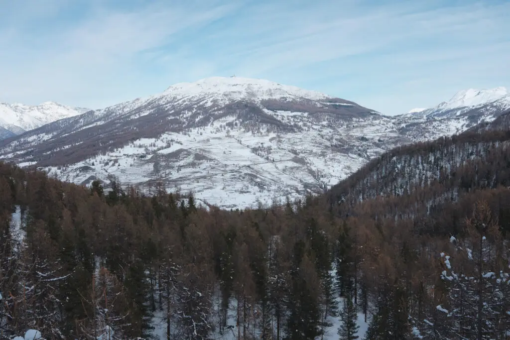 Wide-angle landscape photography of alpine peaks during a snow trek to Bousson